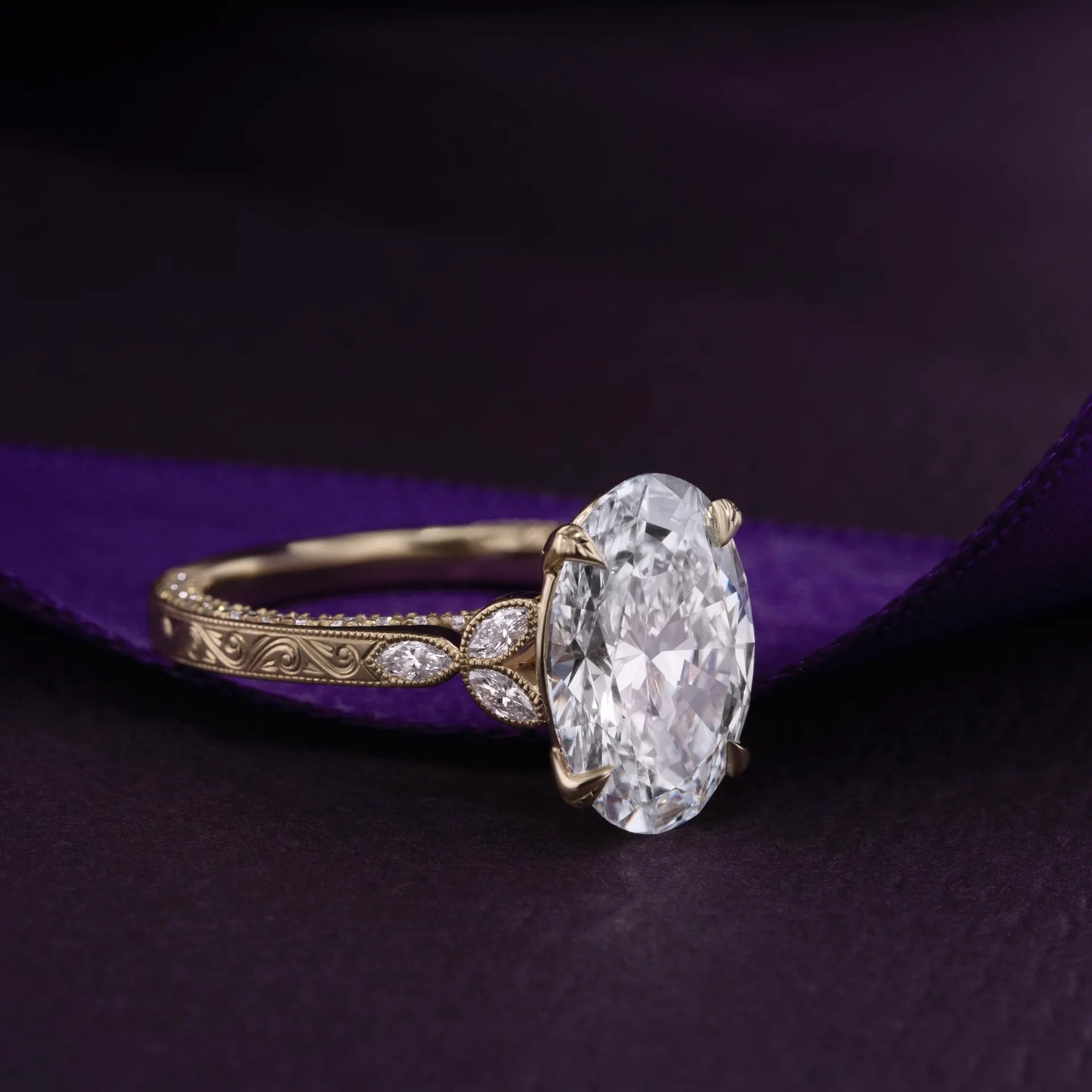 Cathedral solitaire with milgrain bezel shoulders, marquise lab diamond side stones, and leaf-engraved prongs.